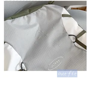 Waterproof hiking backpack detail showing durable grey grid fabric and adjustable straps.