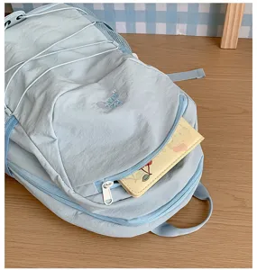 Light blue casual backpack with drawstring and large capacity for daily school use and travel.
