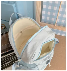 Light blue casual canvas backpack, spacious daily school bag with secure zipper closure.