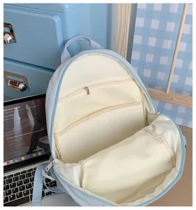 Detail view of the light blue casual backpack showing its interior compartments and capacity.