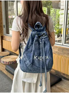 Vintage washed denim backpack with drawstring closure, casual large capacity student commuting bag.