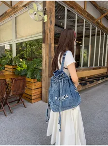 Vintage washed denim backpack for women, retro casual student bookbag with large capacity.