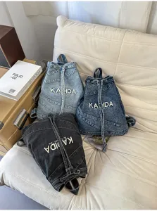 Detail view of Korean vintage washed denim backpack, casual student commute large capacity bag.