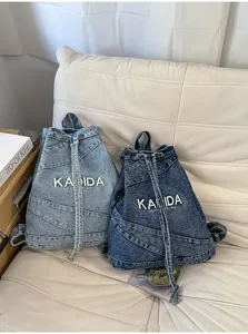 Close-up of vintage washed denim backpack details, retro blue canvas daily commuting bag.