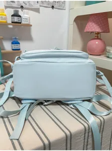 Vista detallada de mochila informal azul claro, bolso escolar ideal para estudiantes y trabajo.