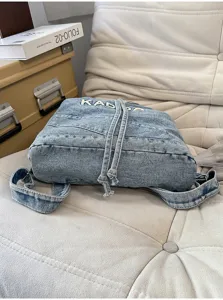 Vintage washed denim backpack for women, casual student schoolbag, large capacity commuter travel bag.