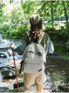 Sac à dos de voyage décontracté en gris clair, grand tissu pour l'usage quotidien.