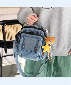 Casual denim shoulder bag with multi-pockets, stylish crossbody bag featuring cute bear pendant.