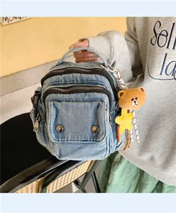 Casual denim crossbody bag with multi-zippers and cute bear pendant for daily fashion use.