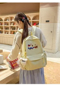Casual student backpack detail showcasing cute puppy embroidery and large daily campus storage capacity.