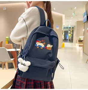 Navy blue casual school backpack with cute puppy embroidery and plush bunny pendant for daily use.