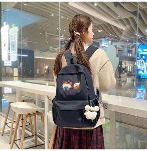 Minimalist women school backpack with cute embroidery and bear pendant for daily campus use.