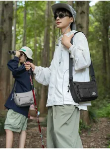 Escena de viaje al aire libre muestra detalles del bolso cruzado de nylon en el bosque.