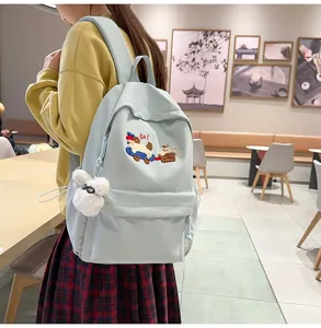 Cute light blue casual school backpack detail view featuring sweet cartoon embroidery style.