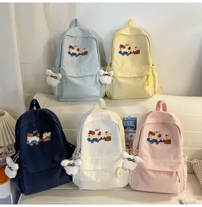 Casual canvas backpack with cute plush pendant and embroidery, stylish school bag for students.