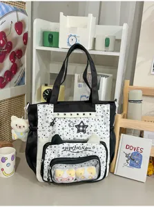 Zwarte en witte canvas itabag met transparant voorvenster, kattenoren en sterren.