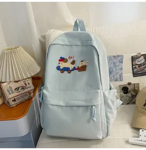 Casual minimalist blue canvas school backpack with cute puppy embroidery and large student capacity.