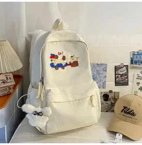 Canvas backpack detail showing cute dog embroidery, spacious compartments and daily aesthetic style.