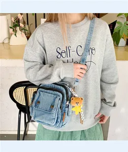 Casual denim crossbody bag with multi pockets and cute bear pendant for daily stylish wear.