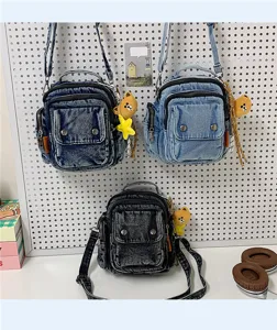 Casual denim crossbody bag for women, stylish shoulder handbag with cute bear pendant.