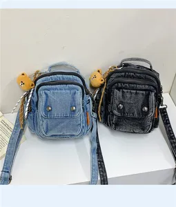 Casual denim mini backpack for women, stylish crossbody shoulder bag with cute bear charm.