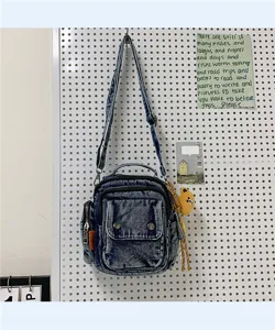 Casual washed denim crossbody shoulder bag with multi-pockets and cute bear pendant style.