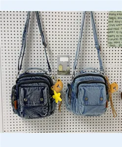 Stylish denim shoulder bag for women casual multi-pocket crossbody bag with cute bear charm.