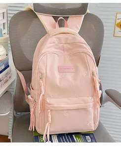 Roze schattige schoolrugzak voor meisjes met strikborduurwerk en een grote capaciteit.