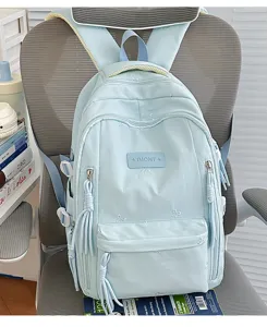 Gedetailleerd overzicht van de lichtblauwe schoolrugzak met strik borduurwerk.