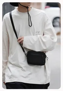 Zwarte casual crossbody tas, minimalistische canvas schoudertas voor dagelijks reizen.
