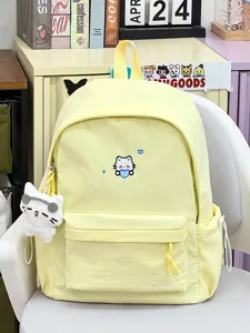 Leuke gele canvas schoolrugzak met kattenborduurwerk en bijpassende pluche hanger.