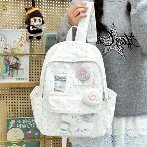 Vista dettagliata dello zaino ita bianco a pois con finestra trasparente e ciondoli in peluche.