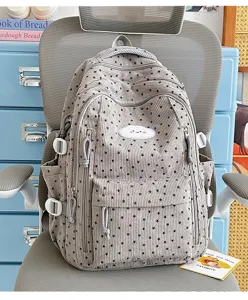 Schattige ribfluwelen schoolrugzak met sterrenprint en meerdere vakken voor tienermeisjes.