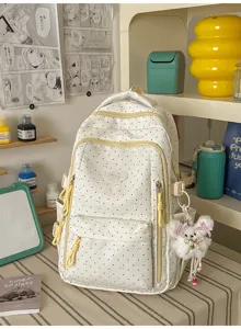 Schattige canvas schoolrugzak met polkadots, gele ritsen en een mooie pluizige hanger.