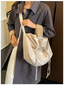 Sac bandoulière minimaliste à cordon, grand sac fourre-tout tendance pour usage quotidien.