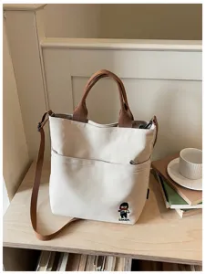 Sac cabas en toile style coréen avec poignée supérieure et bandoulière pour étudiants.