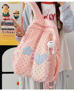 Sweet pink polka dot backpack with lace trim, bunny ears, and cute charms for daily use.