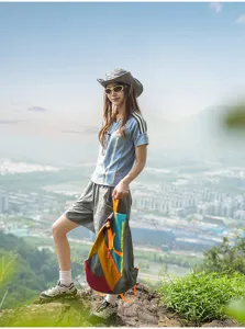 Outdoor foldable backpack with colorful patchwork and orange straps for travel and hiking.