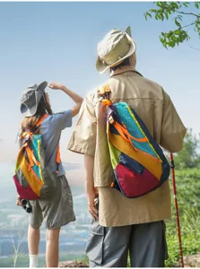 Outdoor folding couple backpack with vibrant multicolored patchwork design for hiking and travel.