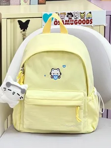 Leuke gele canvas rugzak met kattenborduurwerk en pluche hanger voor schoolgebruik.