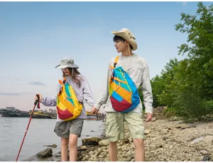 Outdoor couple travel scene detail, colorful patchwork sling backpack, portable and stylish.