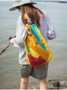 Colorful geometric patchwork outdoor backpack, durable lightweight travel daypack for hiking and sports.