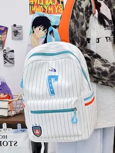 Closeup of striped canvas backpack with number 7 and blue zipper detail in casual room.
