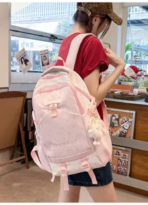 Sac à dos rose de grande capacité pour femmes, léger et pratique pour l'école et les voyages.