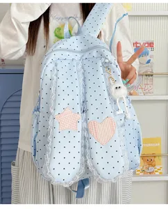 Sweet blue polka dot bunny ear backpack detail, cute lace trim and star heart patch design.
