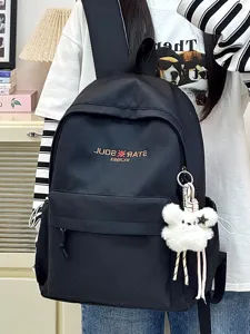Minimalistischer schwarzer Studenten Rucksack, lässiger lächender Alltagsschulranzen mit Anhänger.