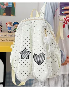 Sweet lace polka dot bunny ear backpack detail showcasing cute star and heart patch design.