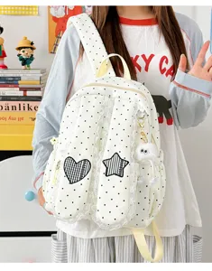 Detailed view of sweet polka dot backpack with lace trim, cute heart and star patches.