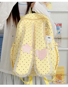 Sweet yellow polka dot backpack with lace bunny ears, star heart patches, and cute pendant.