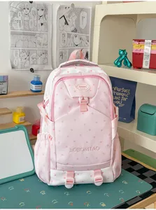 Vue détaillée du sac à dos rose et blanc avec motif d'étoiles pour l'école et les voyages.